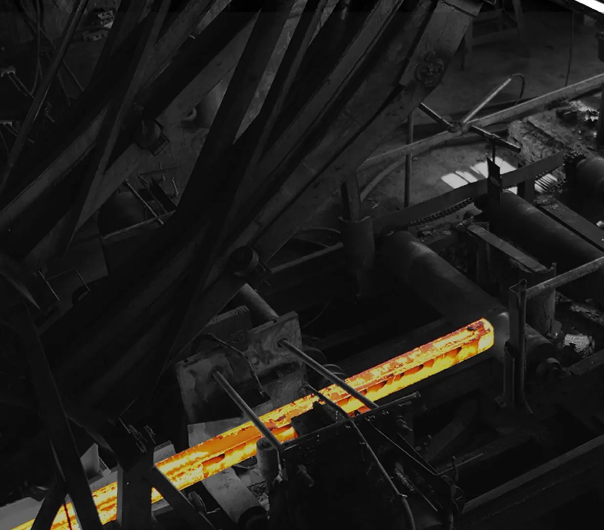 A red-hot steel billet running through the Batala Steel rolling mill
